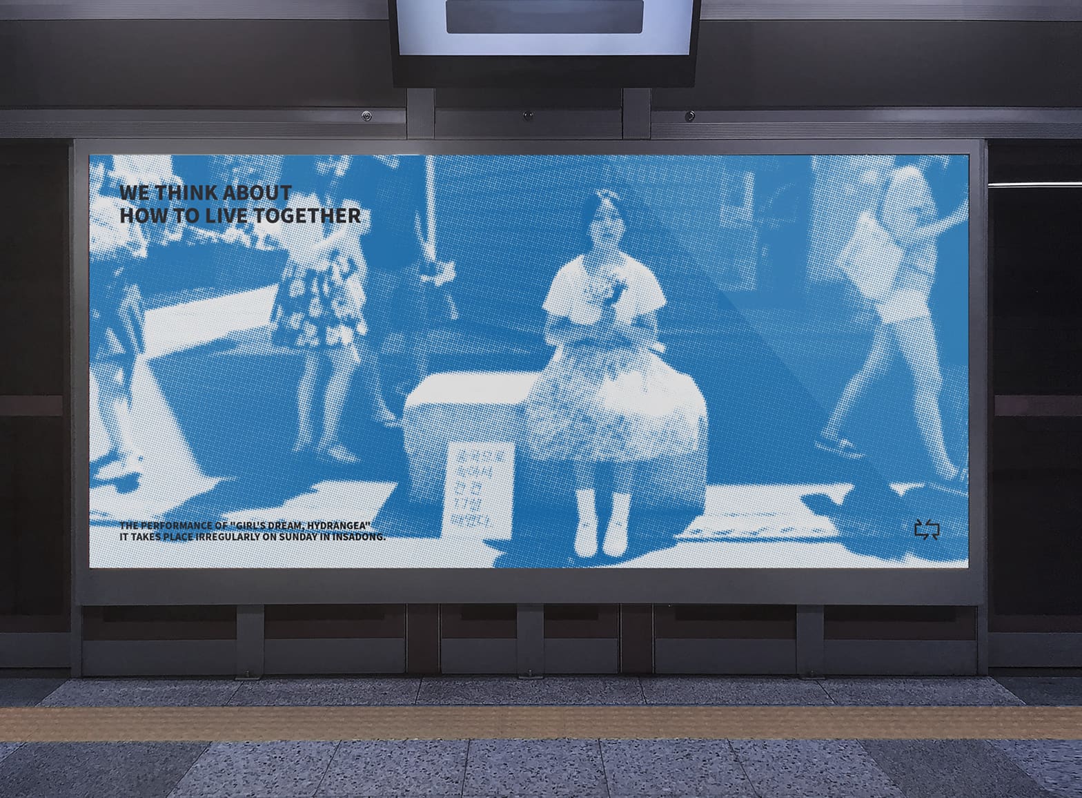 Subway platform billboard — a blue halftone street photograph headlined "We think about how to live together."