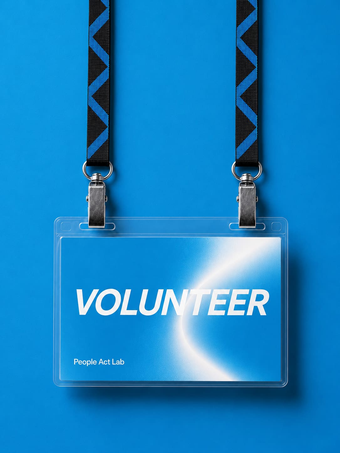 A VOLUNTEER lanyard badge on a chevron-webbed strap, set against the People Act Lab blue.
